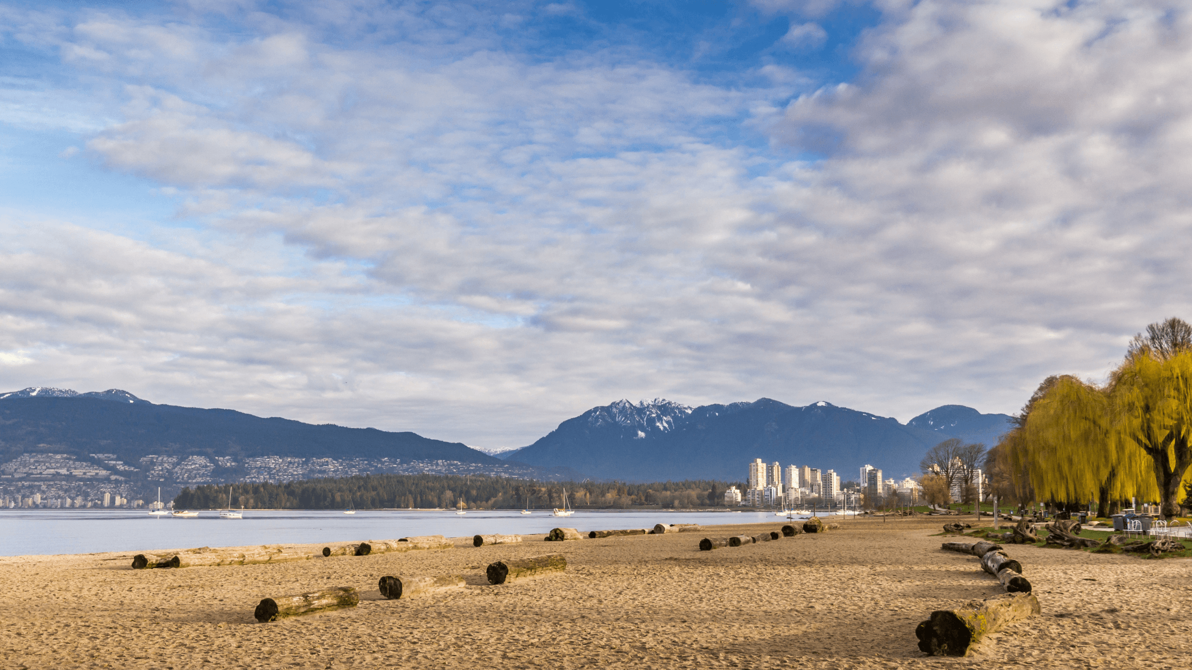 Wide sandy shoreline and city views at Kitsilano Beach in Vancouver