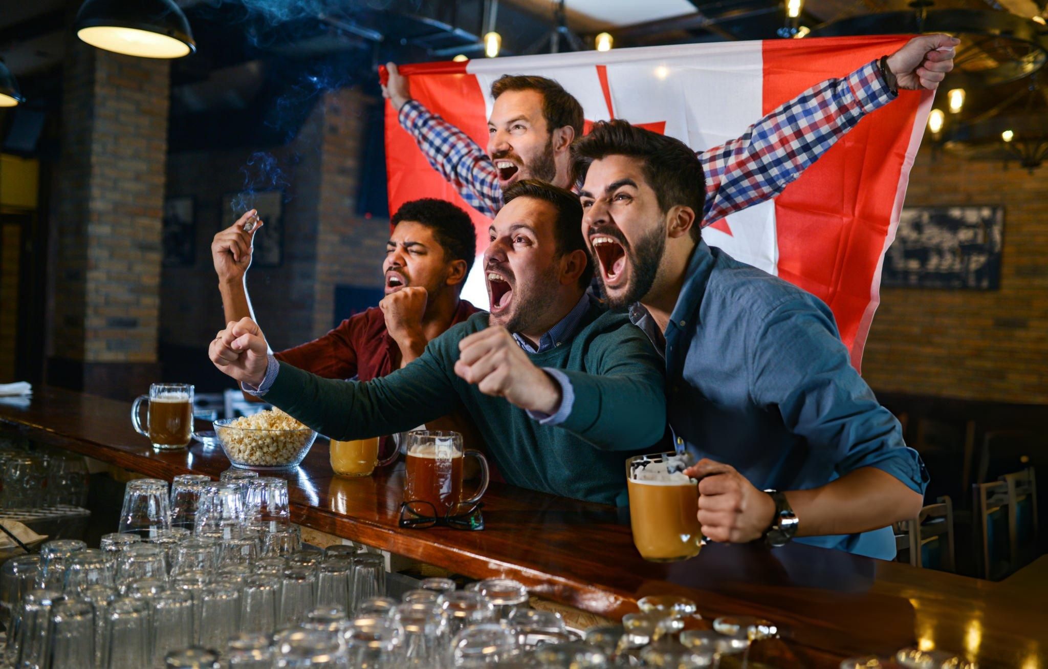 Soccer fans cheering in a Vancouver sports bar